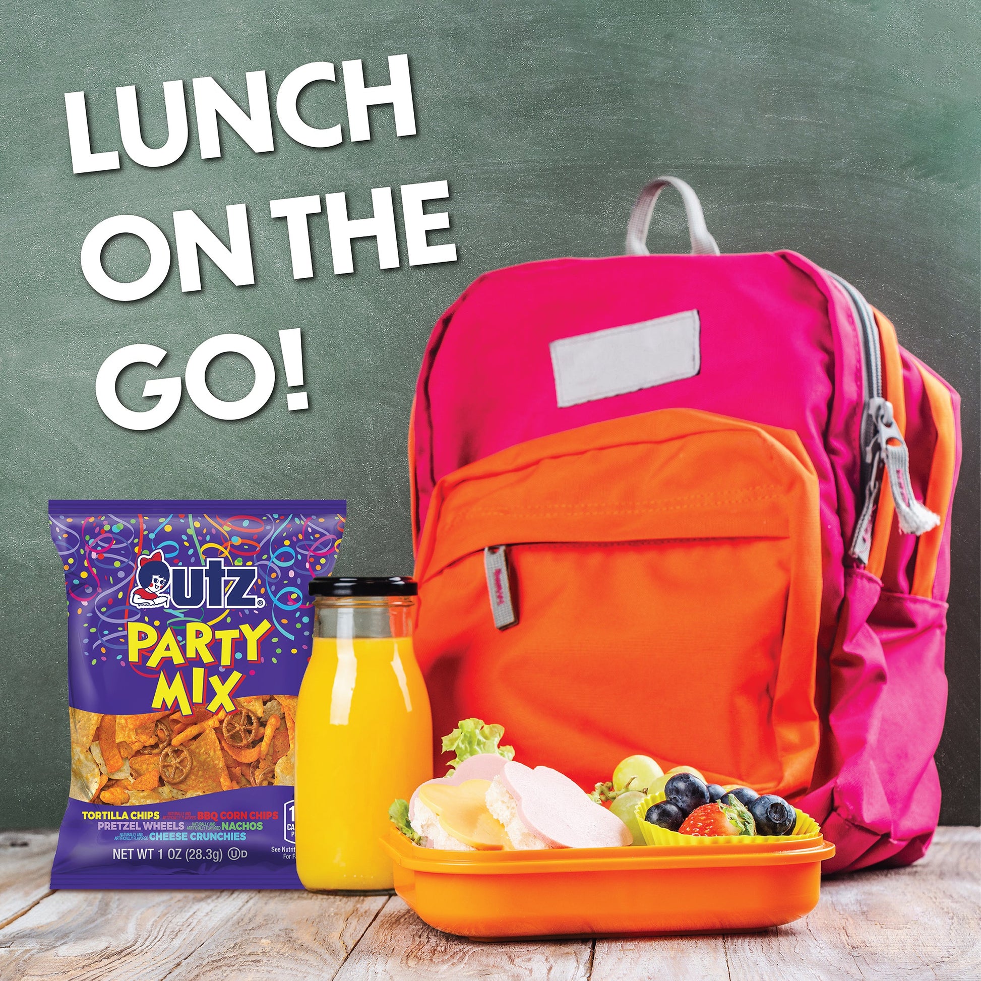 Lunch on the go with a pink and orange backpack, Cuz Party Mix, juice, and a salad.