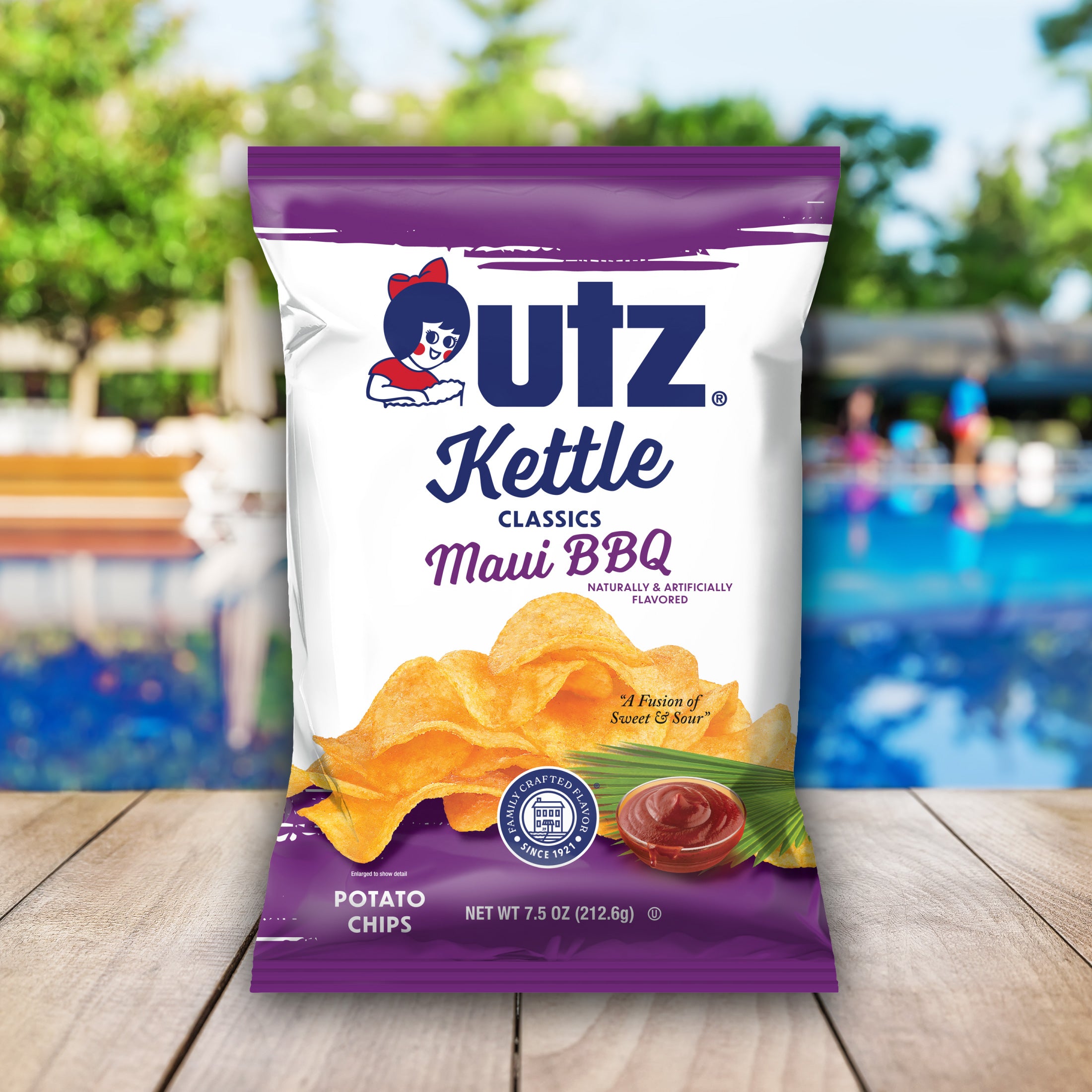 Outz Kettle Classics Maui BBQ potato chips packaging with a blurred outdoor background