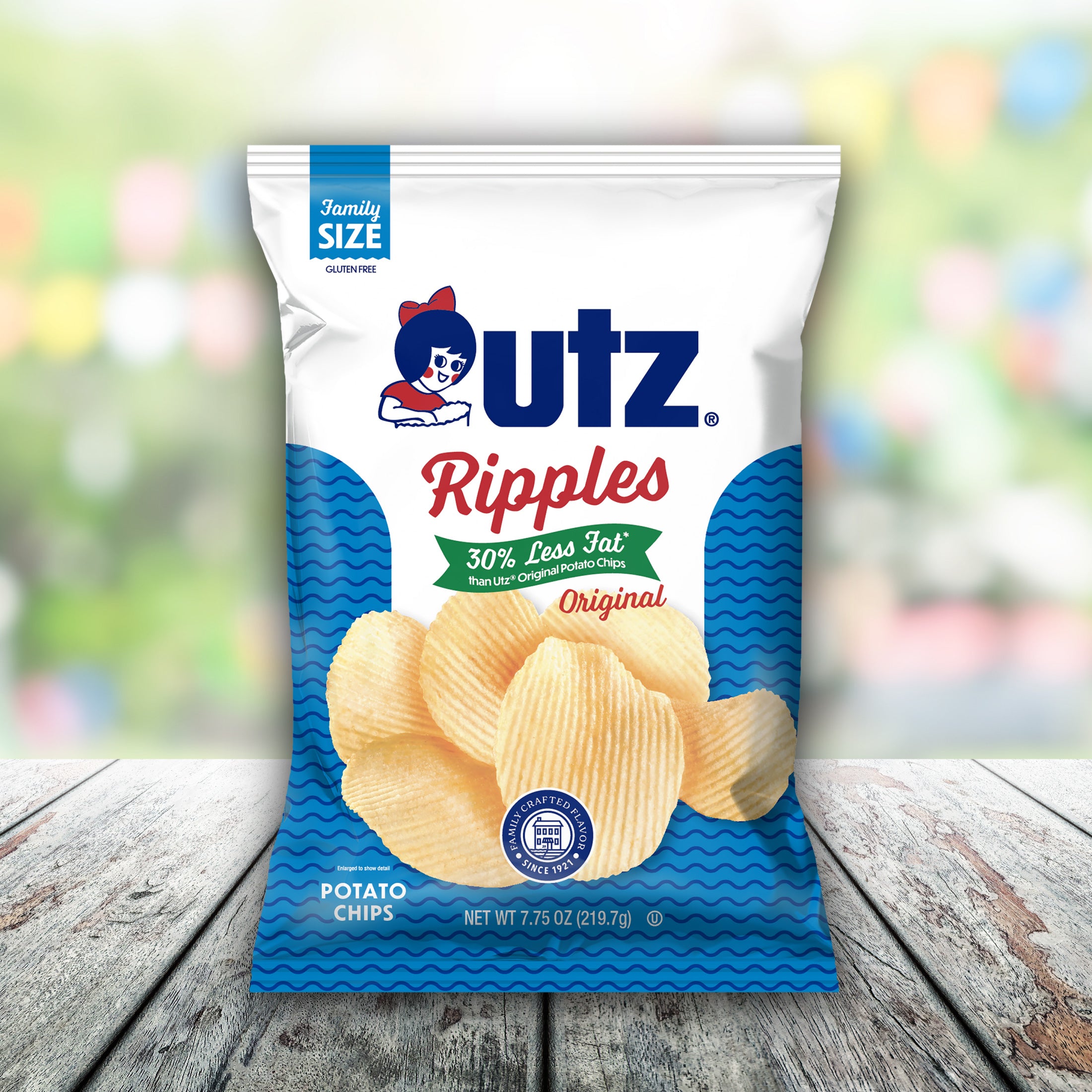 UTZ Ripples potato chips bag on a wooden surface with a blurred colorful background