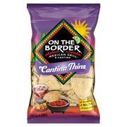 Packaging of 'On The Border Cantina Thins' tortilla chips with purple border and colorful design.