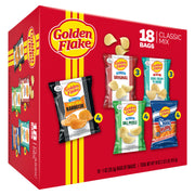 Box of Golden Flake potato chips with various flavors on a red background