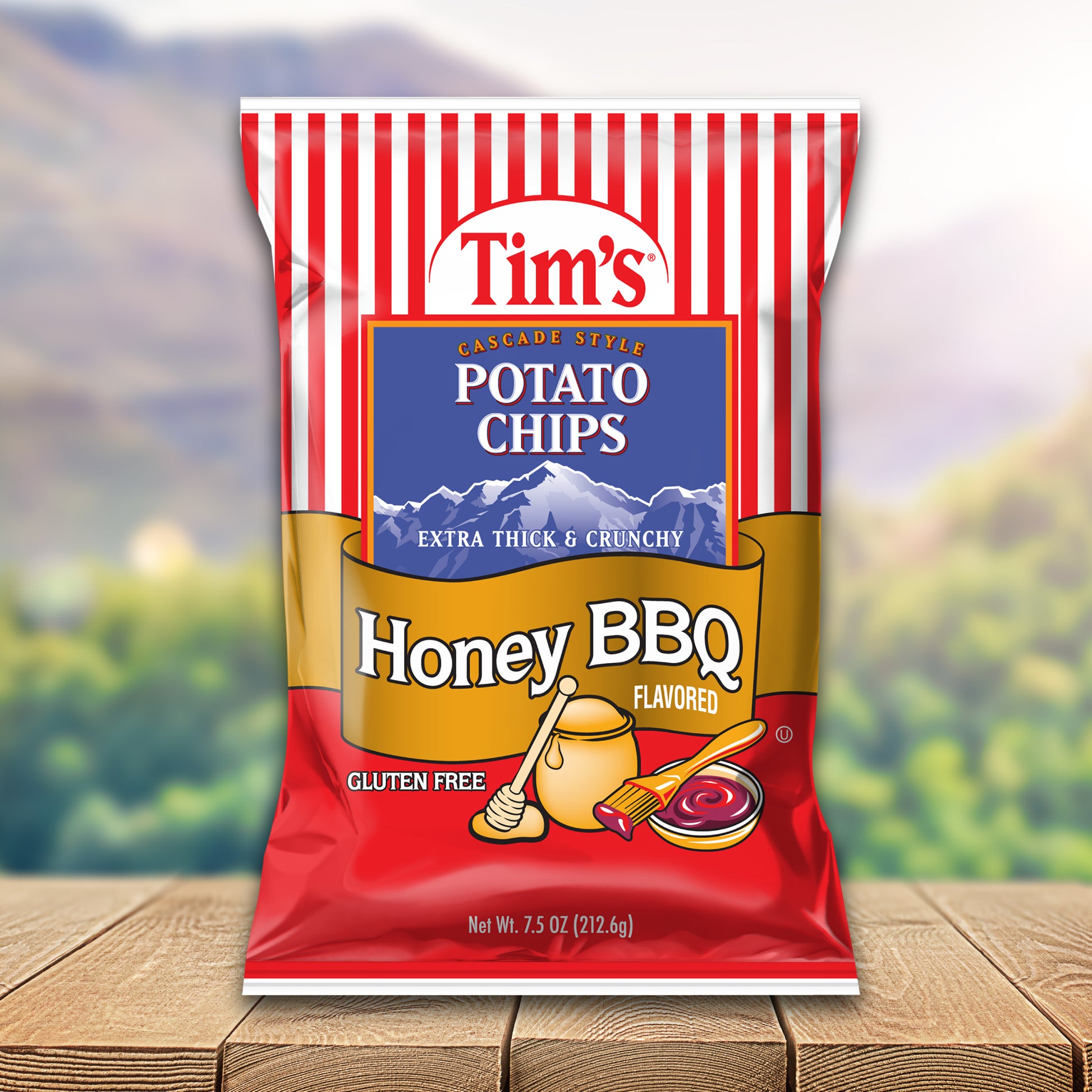 Tim's Honey BBQ flavored potato chips packaging on a wooden surface with a blurred natural background