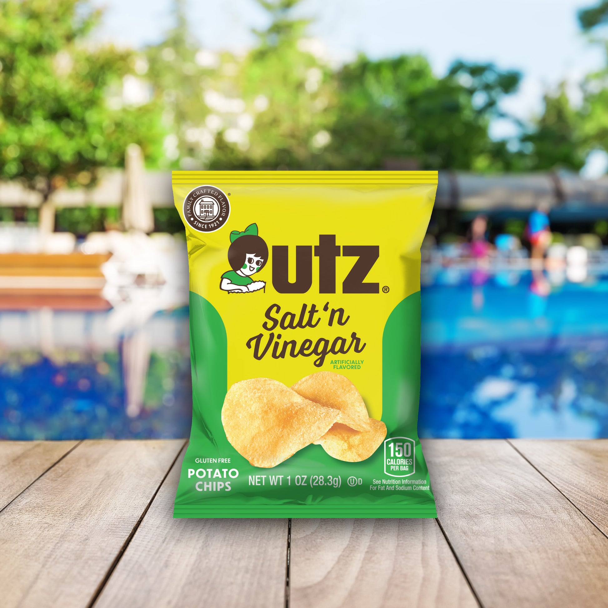 utz Salt 'n Vinegar potato chips packaging on a wooden surface with a blurred outdoor background