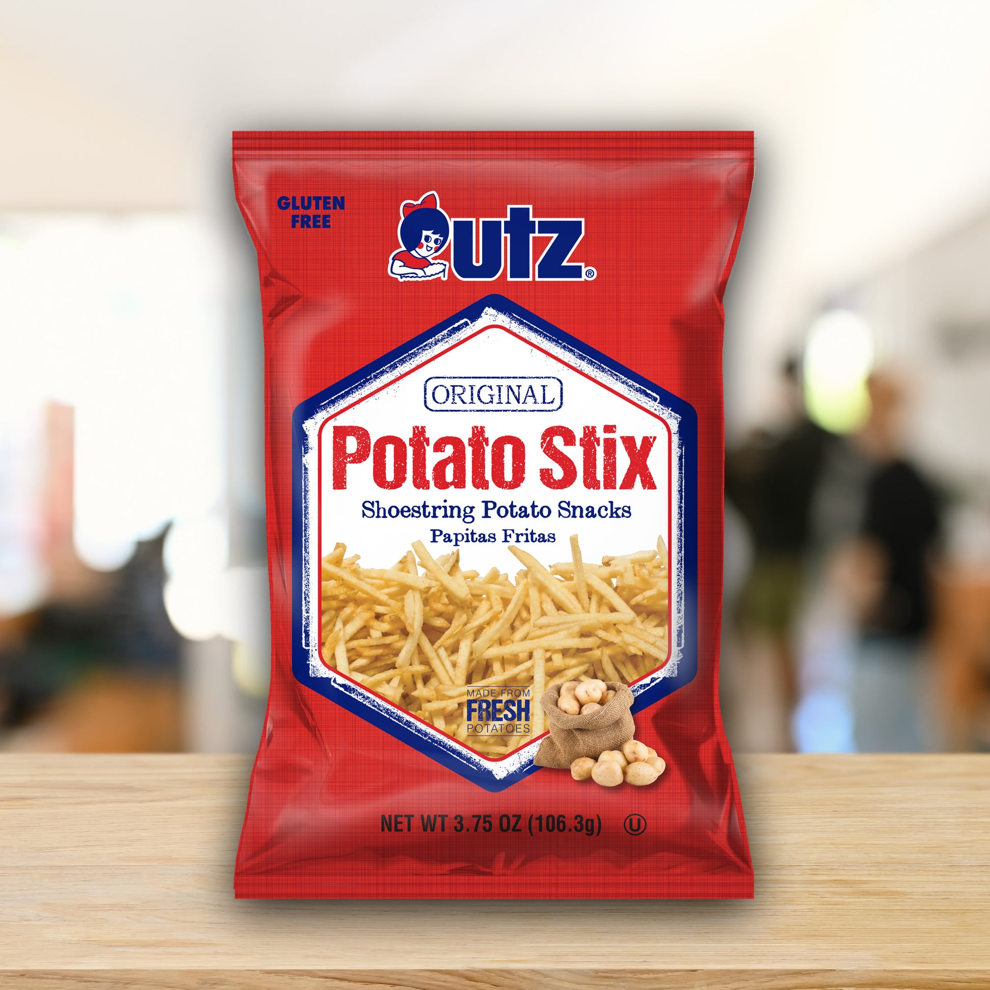 Utz Potato Stix packaging on a wooden surface with a blurred background