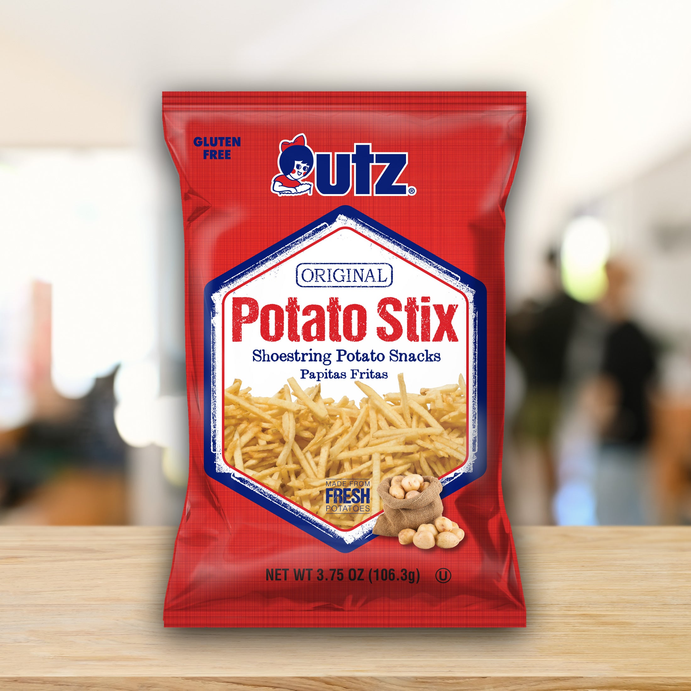 Utz Potato Stix packaging on a wooden surface with a blurred background