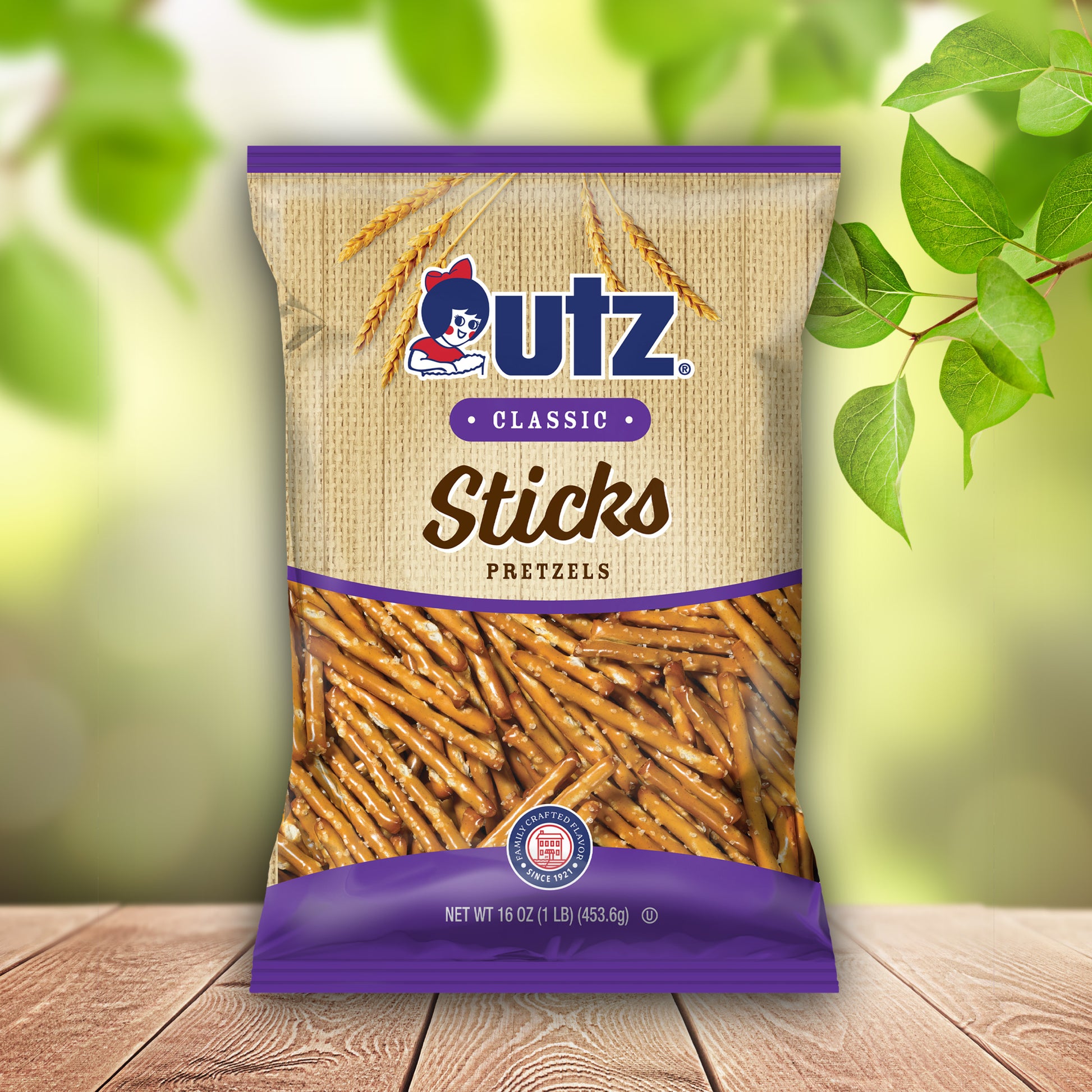 UTZ Classic Sticks Pretzels packaging on a wooden surface with green leaves in the background
