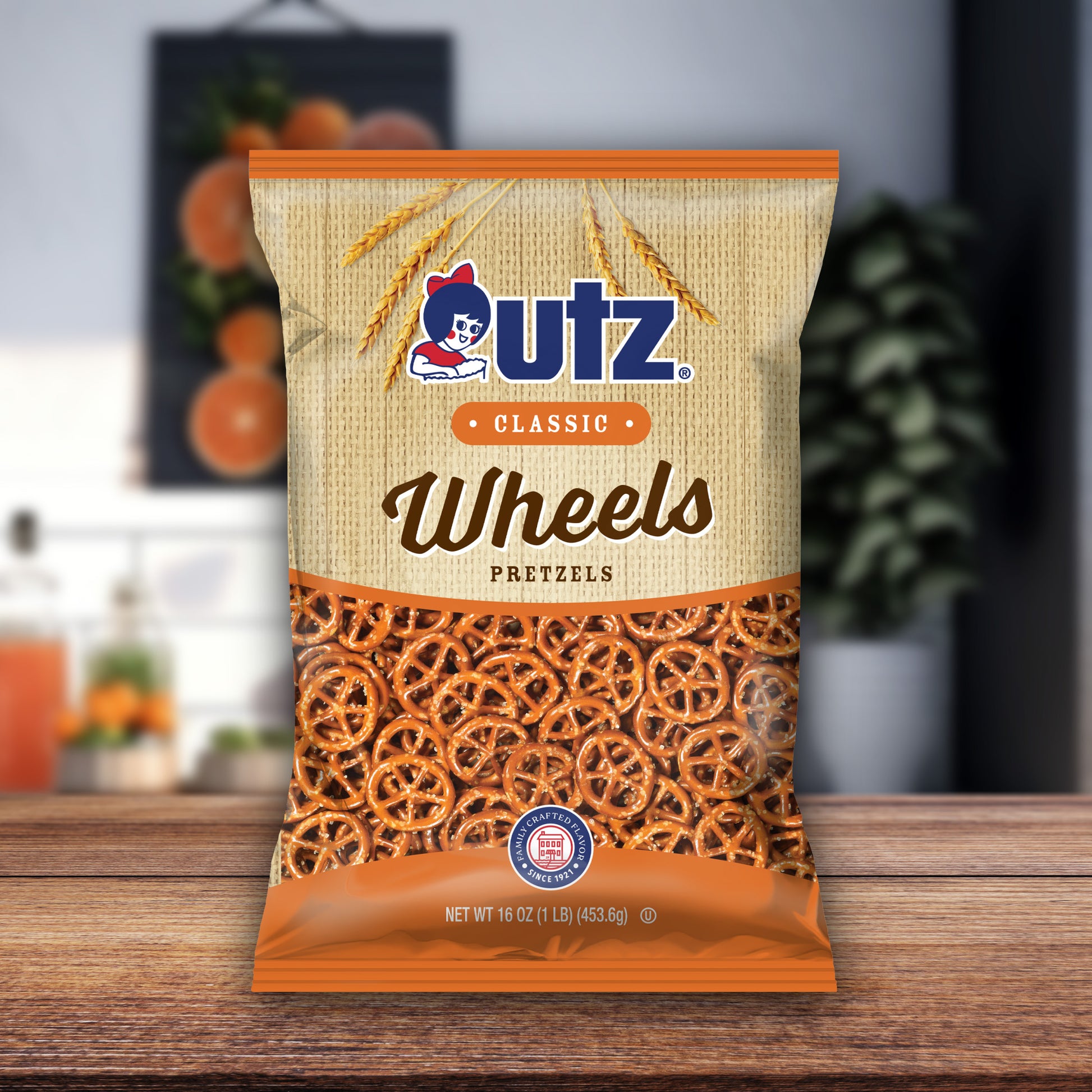 Outz Wheels Pretzels packaging on a wooden surface with a blurred background