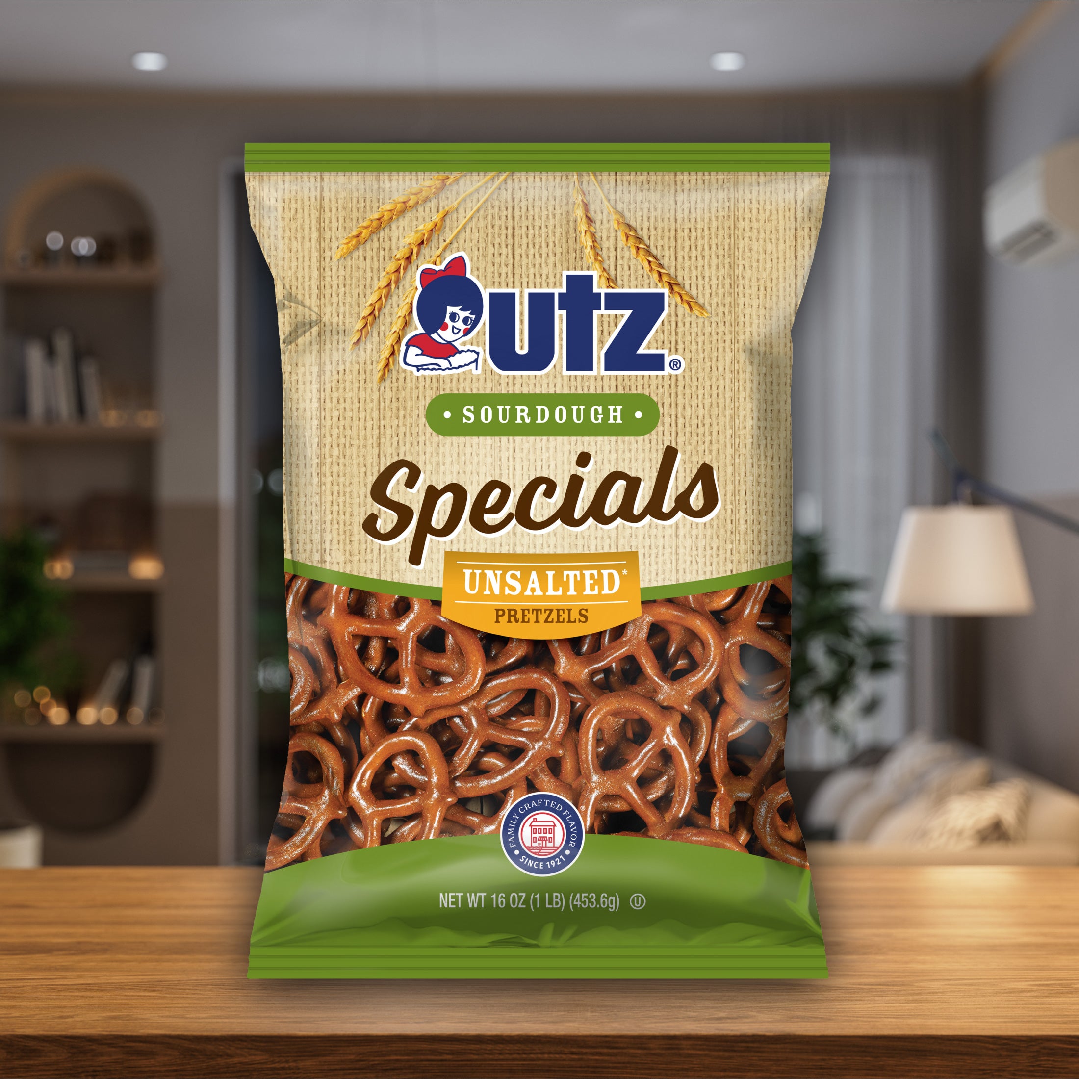 UTZ Sourdough Specials Unsalted Pretzels packaging on a wooden surface with a blurred indoor background