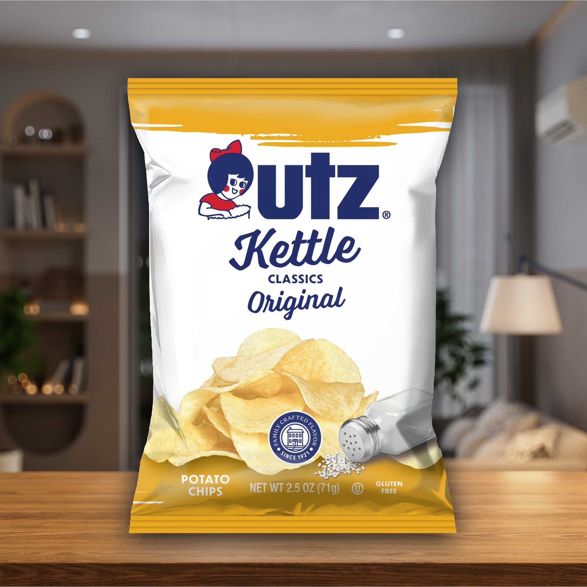 Outz Kettle Classics Original potato chips packaging on a wooden surface with a blurred indoor background