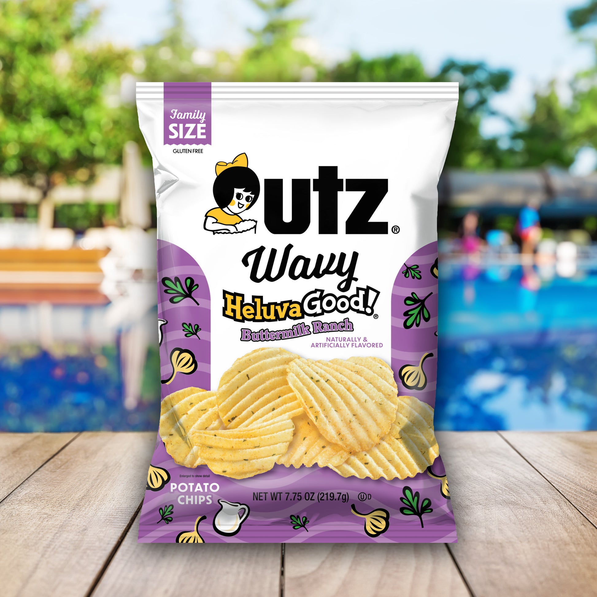 Outz Wavy Heluva Good! potato chips family size bag with a pool and outdoor furniture in the background
