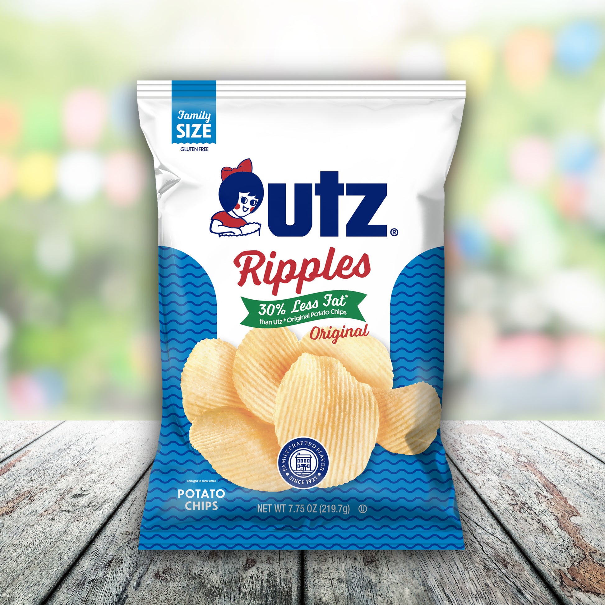 UTZ Ripples potato chips bag on a wooden surface with a blurred colorful background