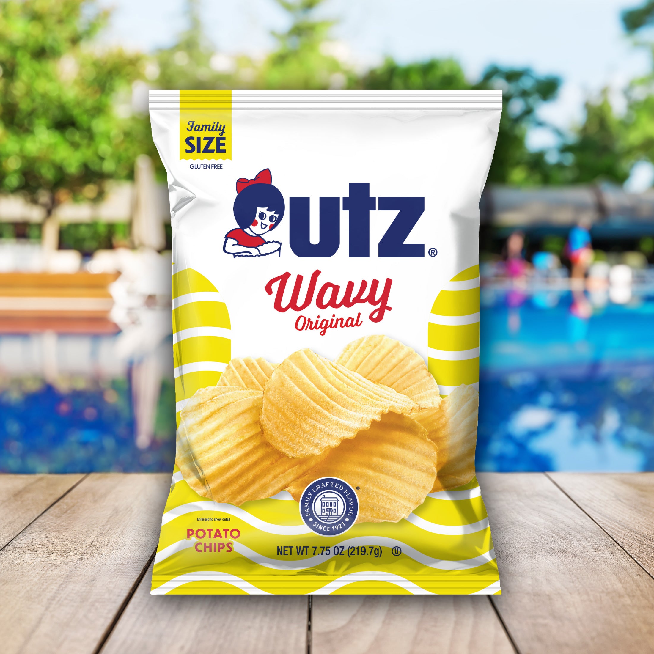 utz Wavy Original potato chips family size bag with a pool and deck in the background