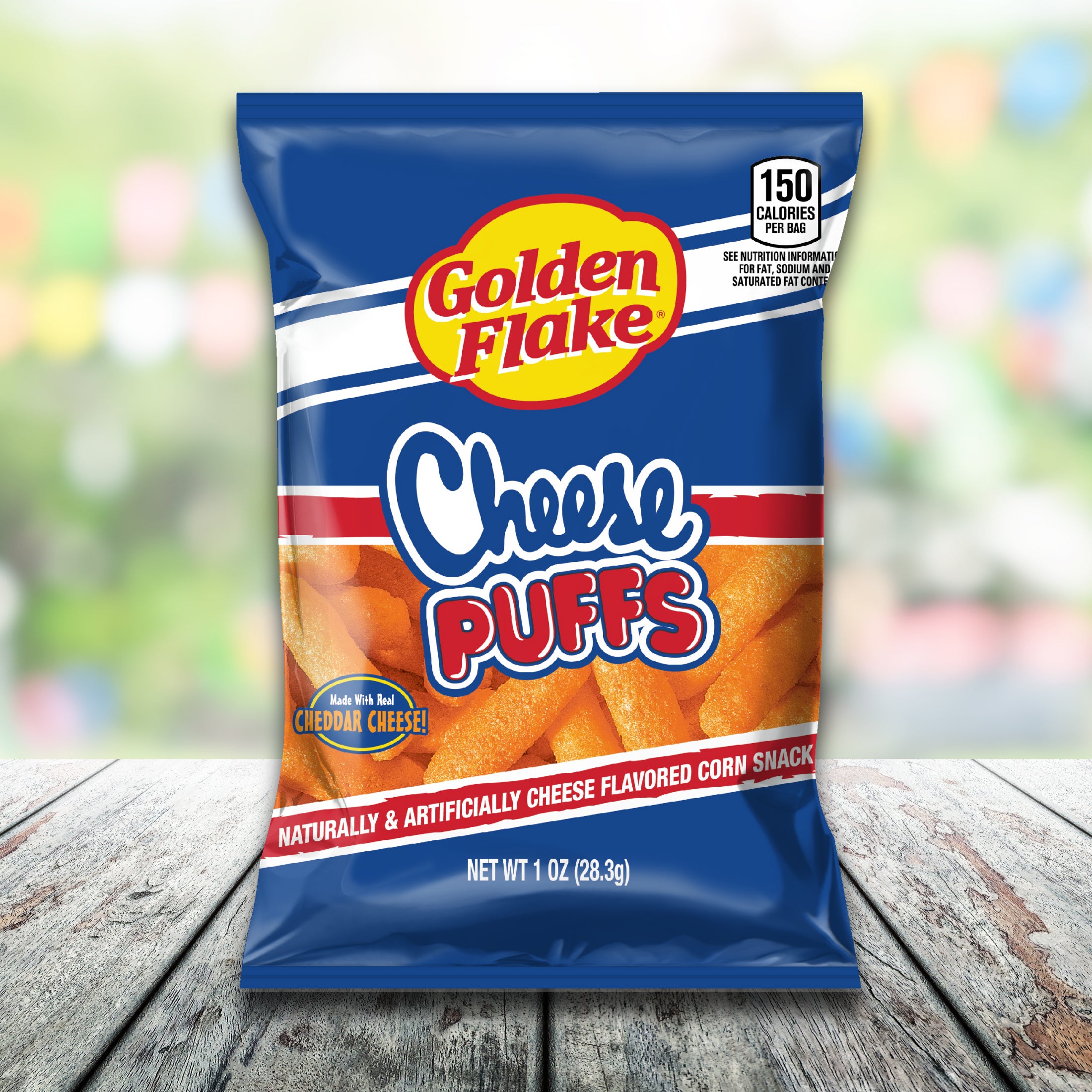 Golden Flake Cheese Puffs bag front on wooden table with blurred background