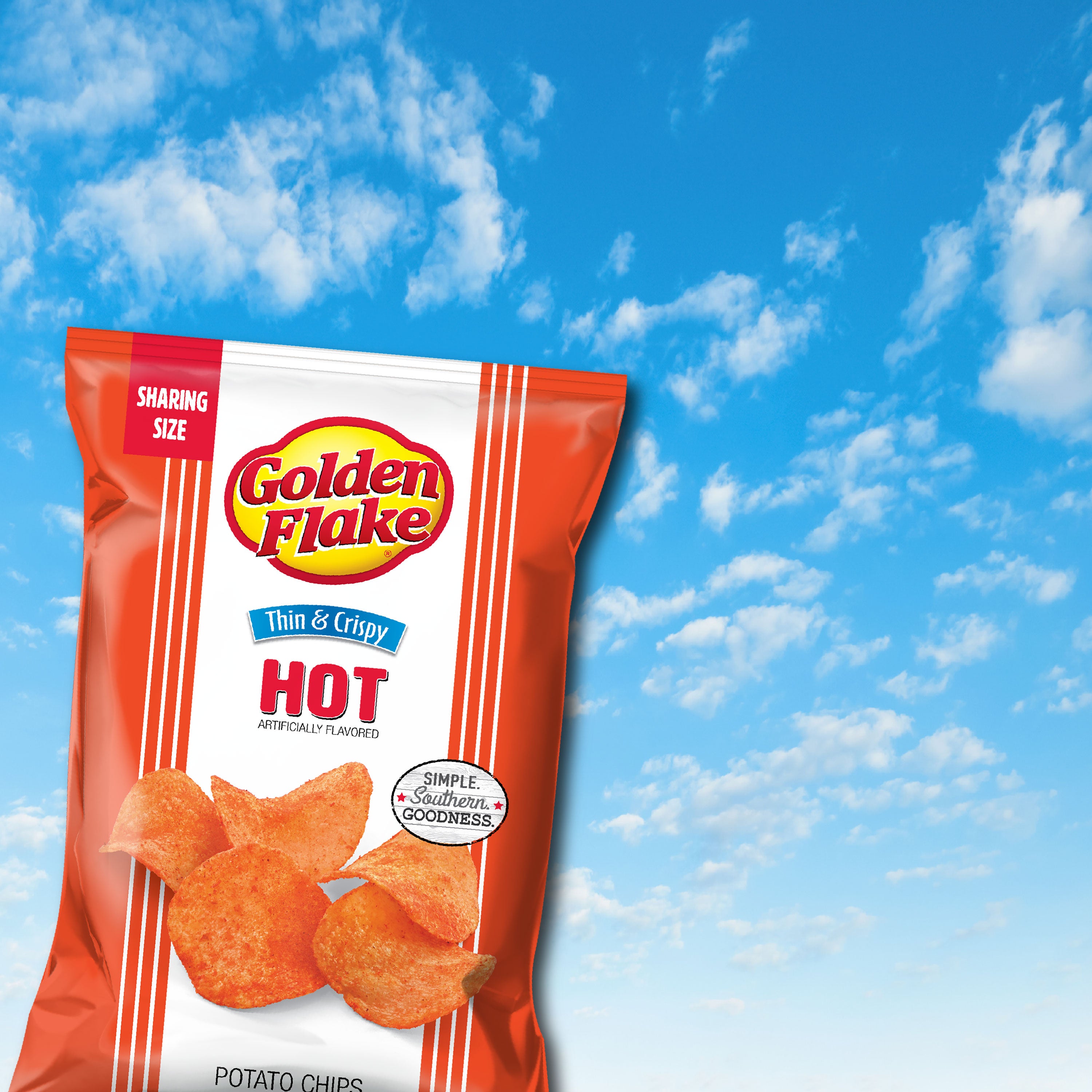 Packaging of Golden Flake Hot potato chips against a blue sky background