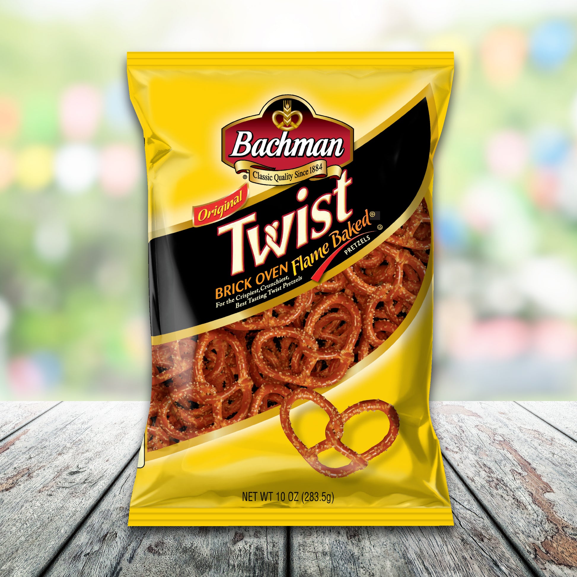 Bag of Bachman Twist pretzels on a wooden surface with a blurred colorful background
