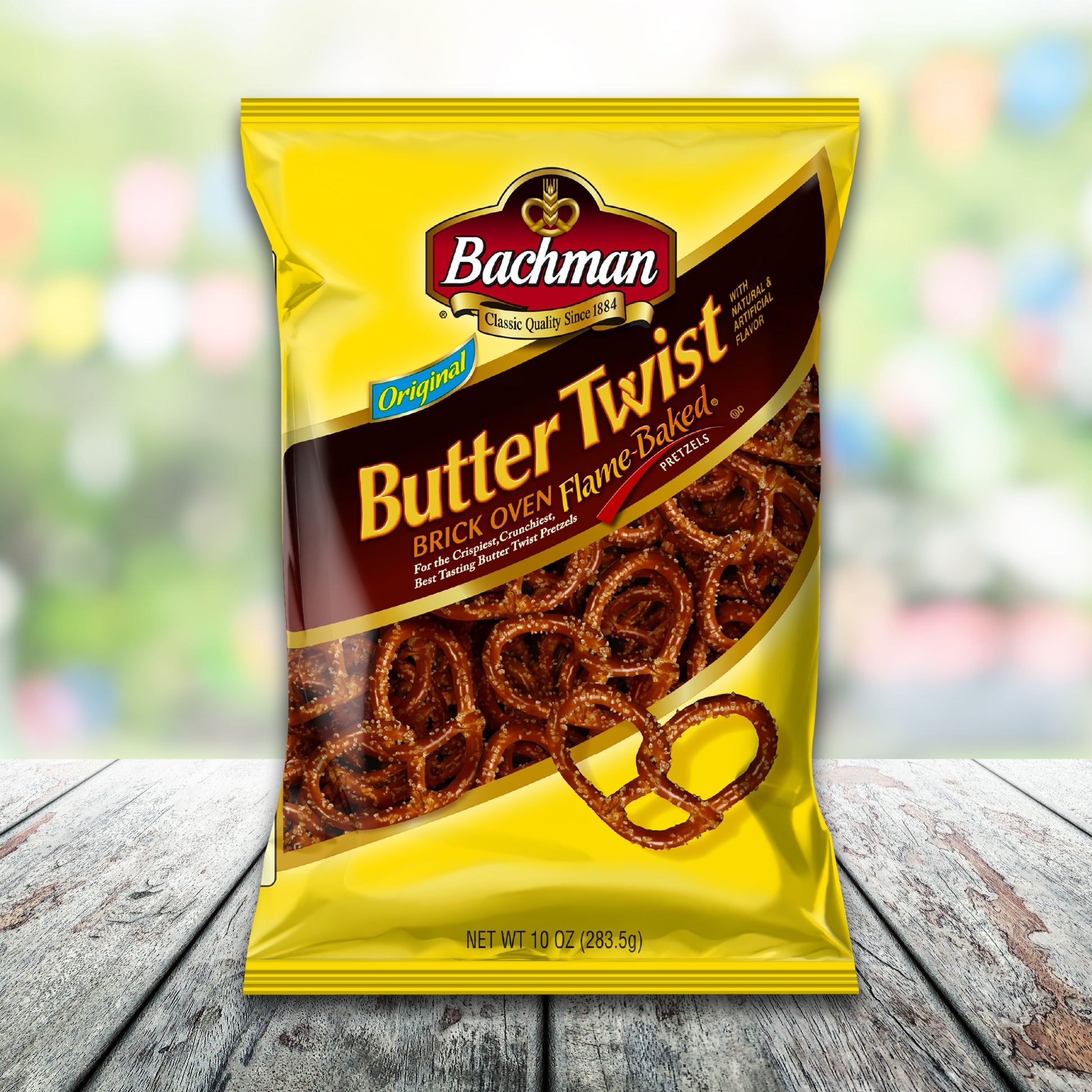 Packaged snack with 'Bachman Butter Twist' on a wooden surface with a blurred colorful background