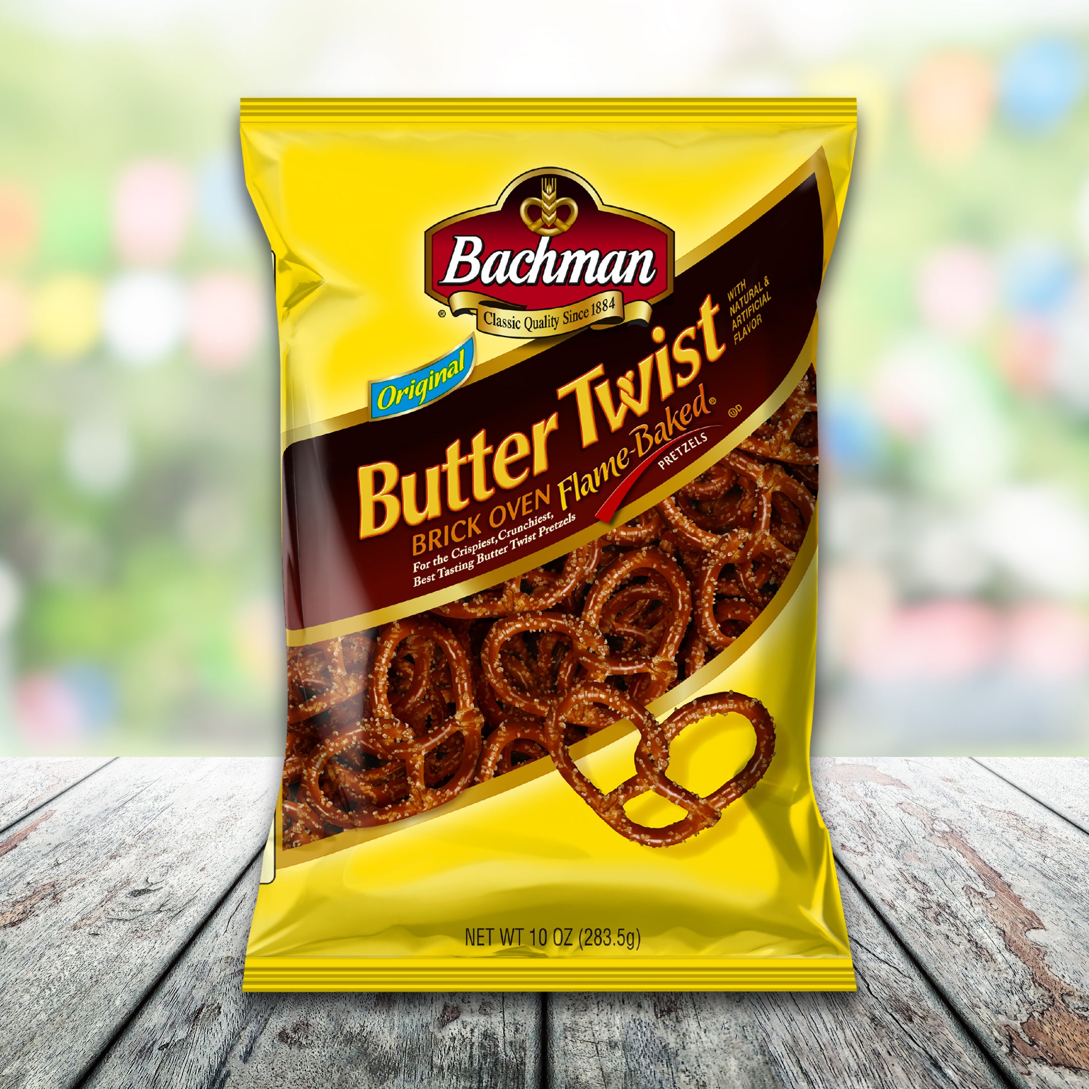 Packaged snack with 'Bachman Butter Twist' on a wooden surface with a blurred colorful background