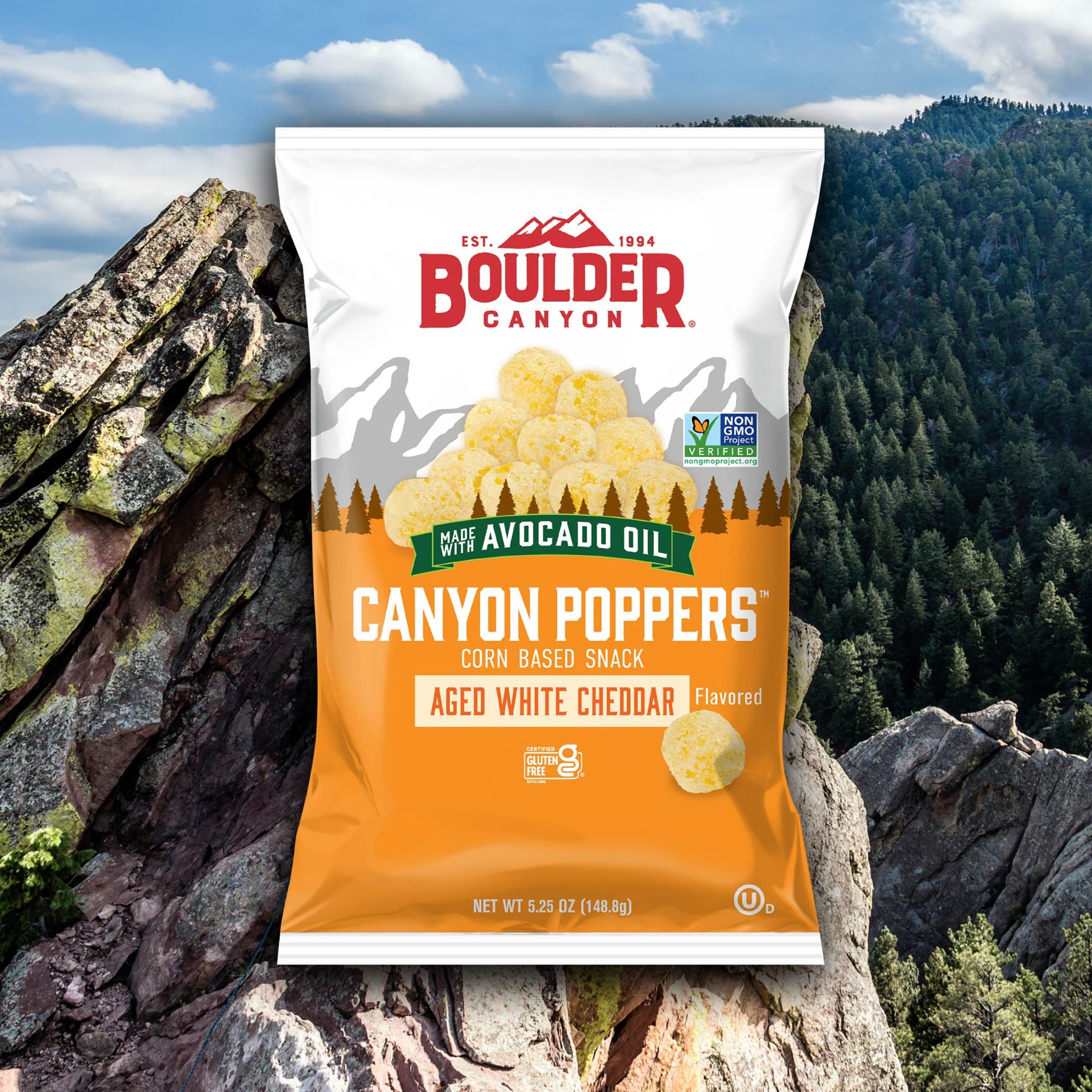 Boulder Canyon Canyon Poppers snack package with a mountainous background