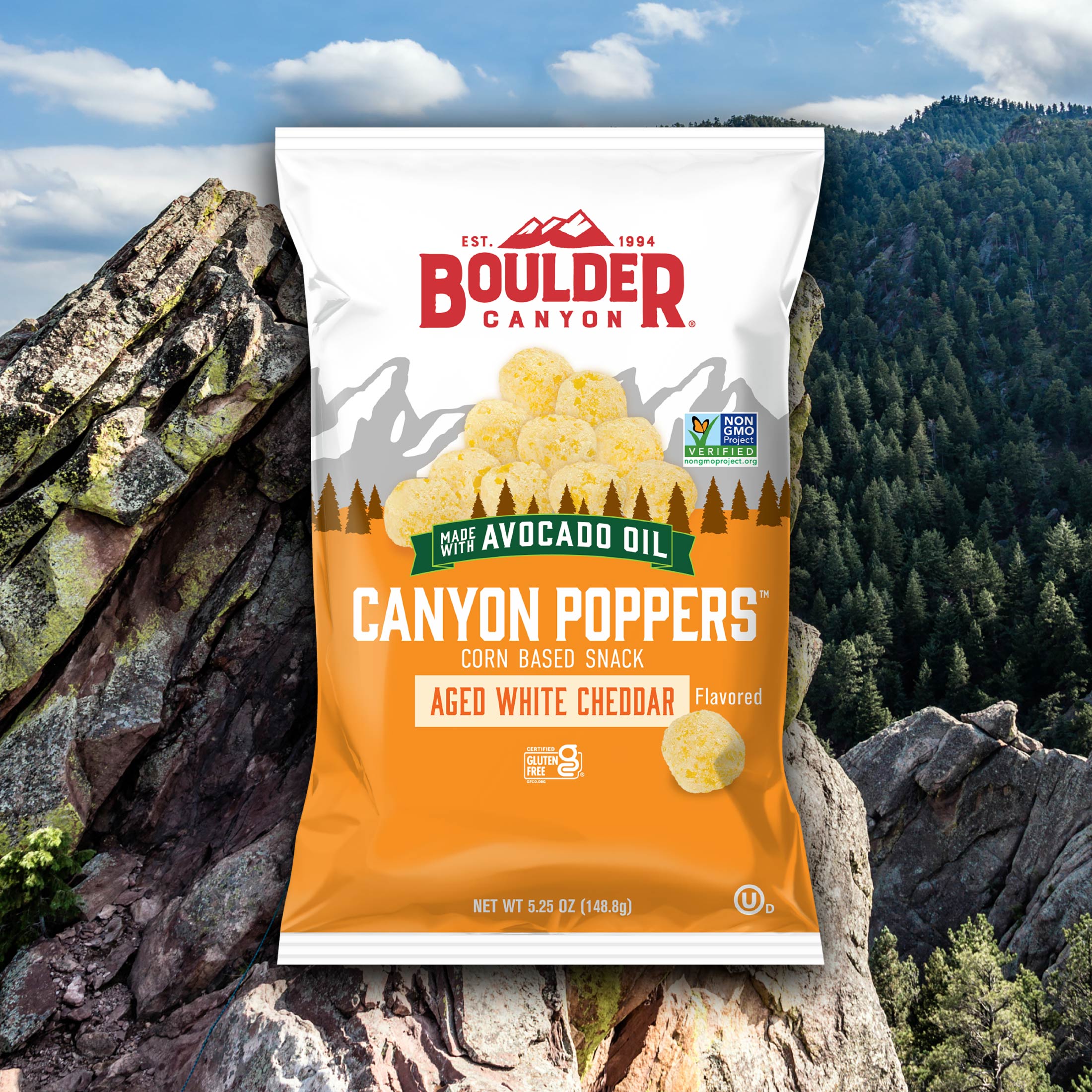 Boulder Canyon Canyon Poppers snack package with a mountainous background