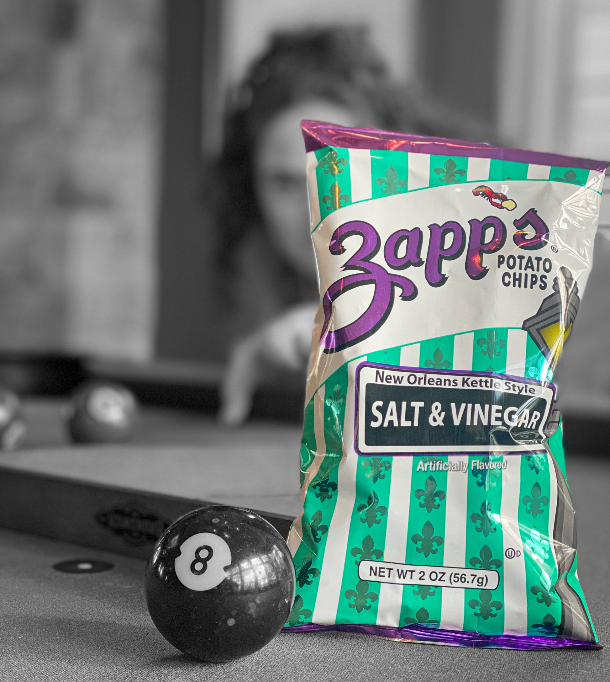 Zapp's Salt & Vinegar potato chips packet with a pool ball on a table.