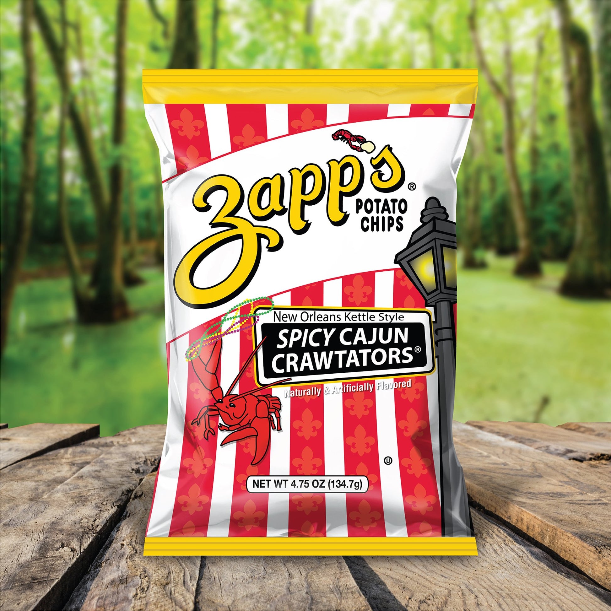 Zapp's Spicy Cajun Crawtators potato chips bag with a forest background