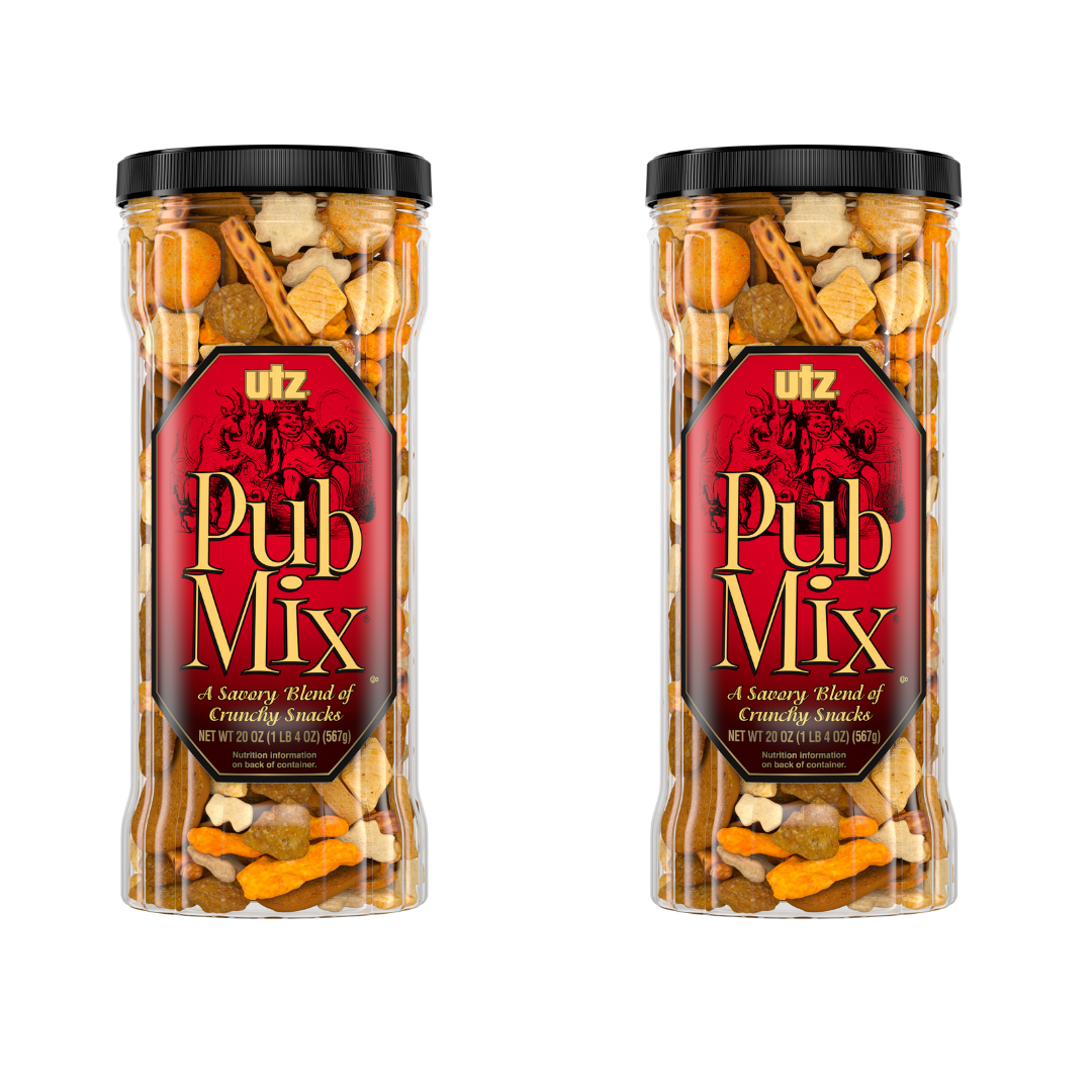 Two transparent containers with black lids, labeled 'Pub Mix' by Utz, filled with a variety of snack foods including pretzels and chips.
