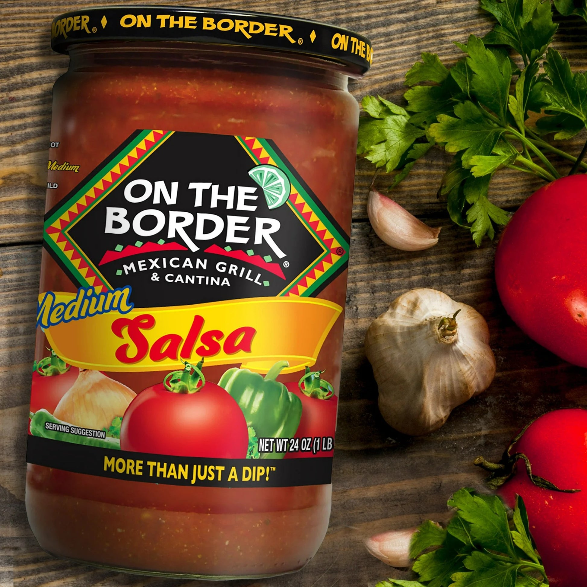 Jar of 'On The Border' salsa with vegetables on a wooden surface