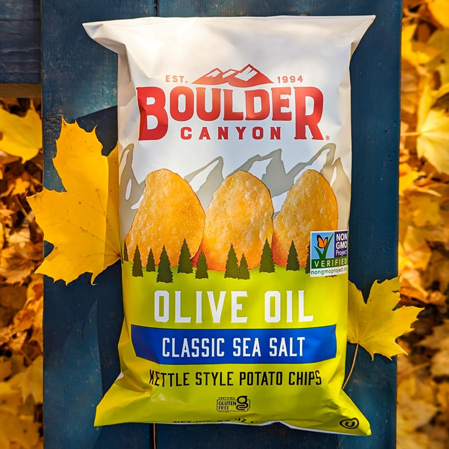 Boulder Canyon olive oil kettle style potato chips packaging with autumn leaves in the background