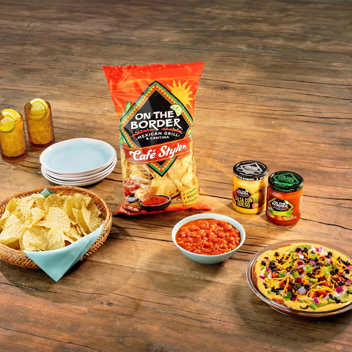 On The Border Mexican Grill & Cafe food items including chips, salsa, and a pizza on a wooden table.
