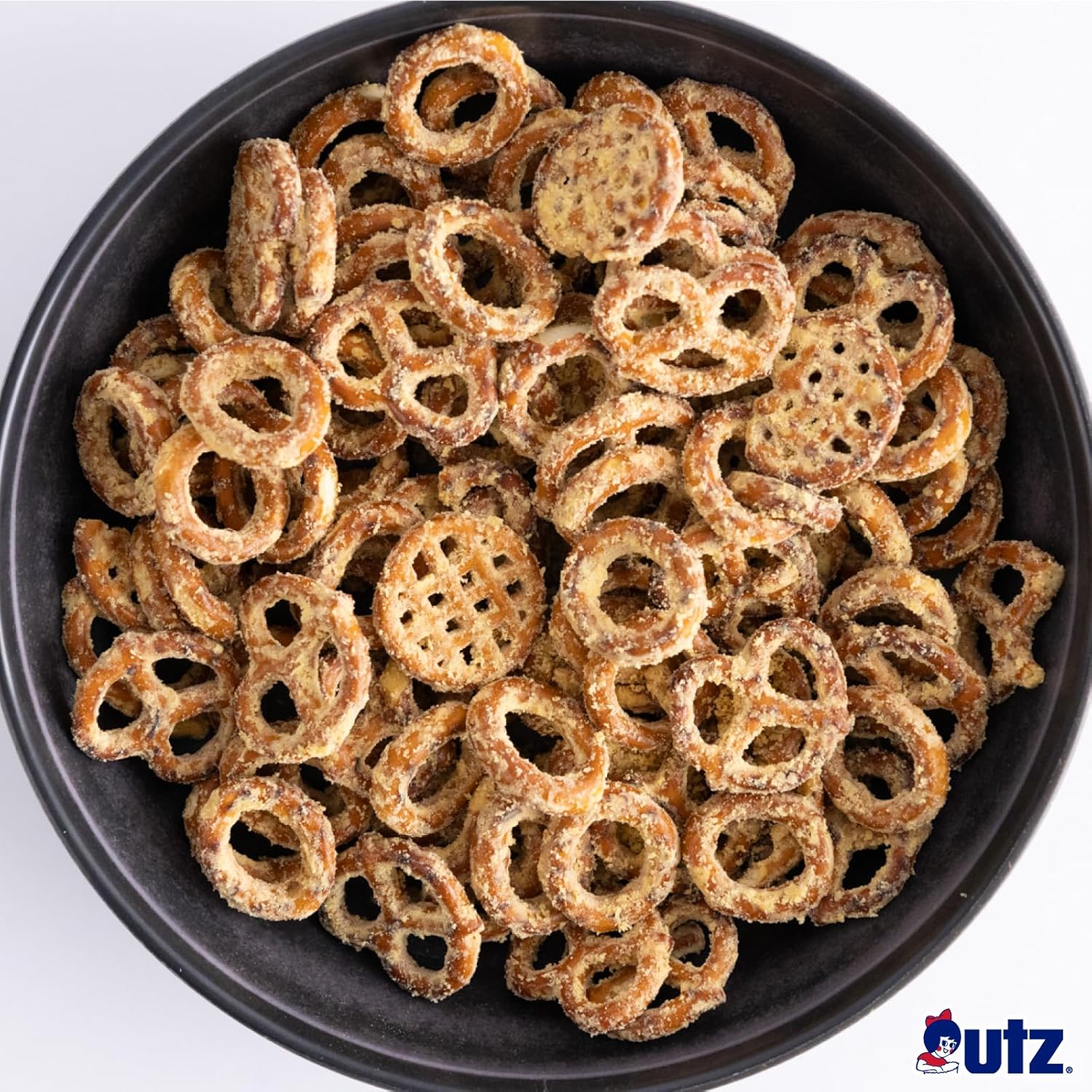 Black bowl filled with pretzel snacks on a white background, featuring the Utz brand logo.