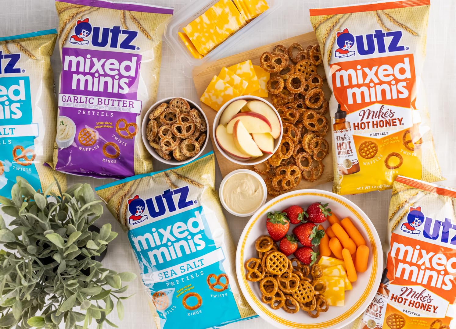 Assorted Utz mixed minis snack packages with snacks on a table.