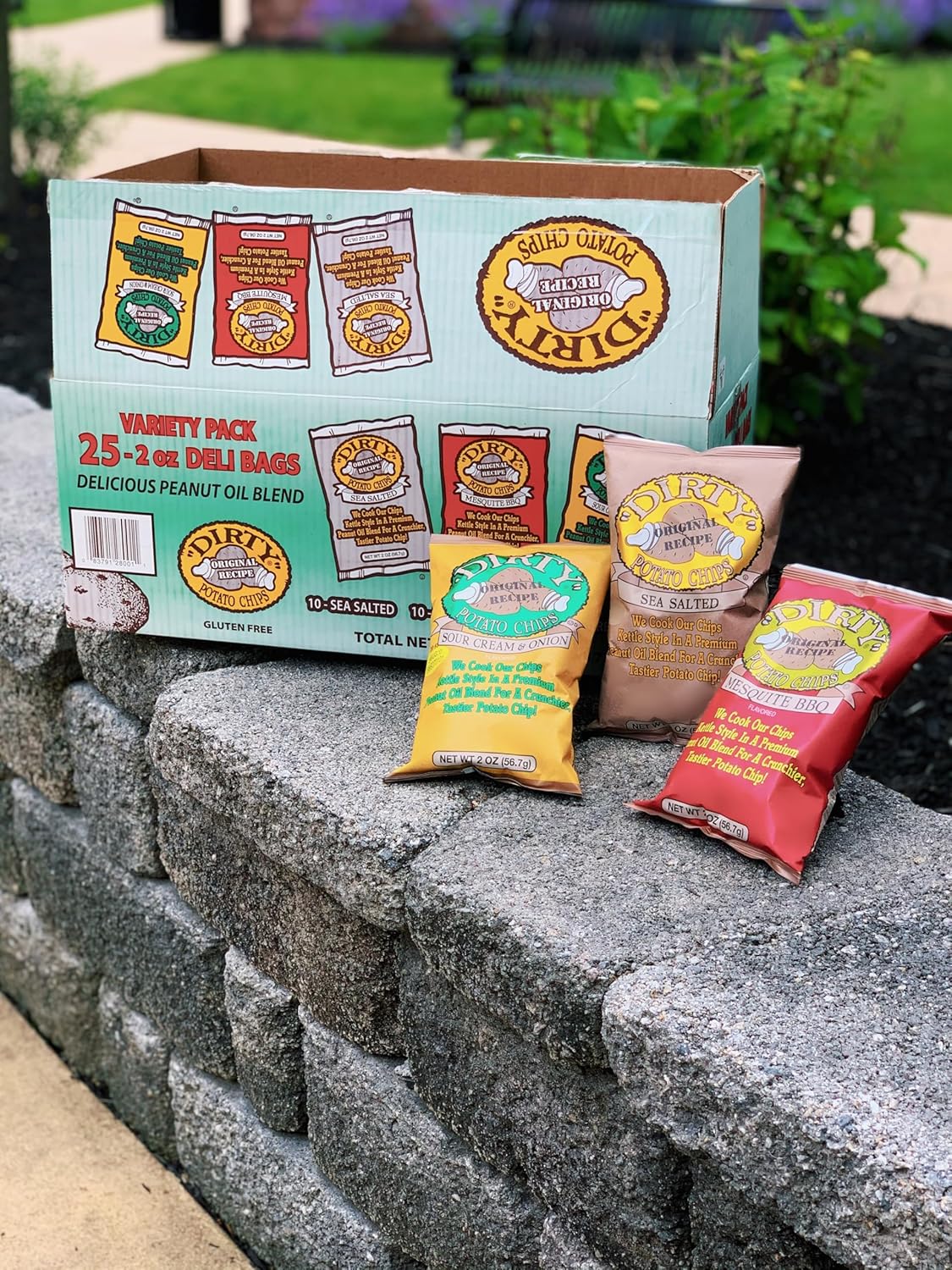 Peanut butter bags and a box on a stone ledge with greenery in the background