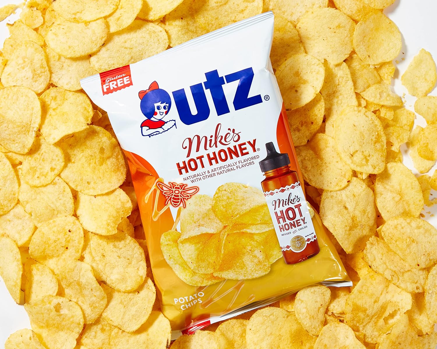Outz potato chips with a bottle of Mike's Hot Honey on a bed of chips