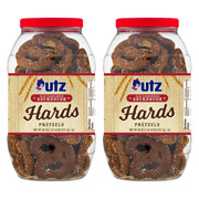 Two clear plastic barrels of Utz Old Fashioned Sourdough Hards Pretzels with red lids and labels, containing pretzels visible through the jars.