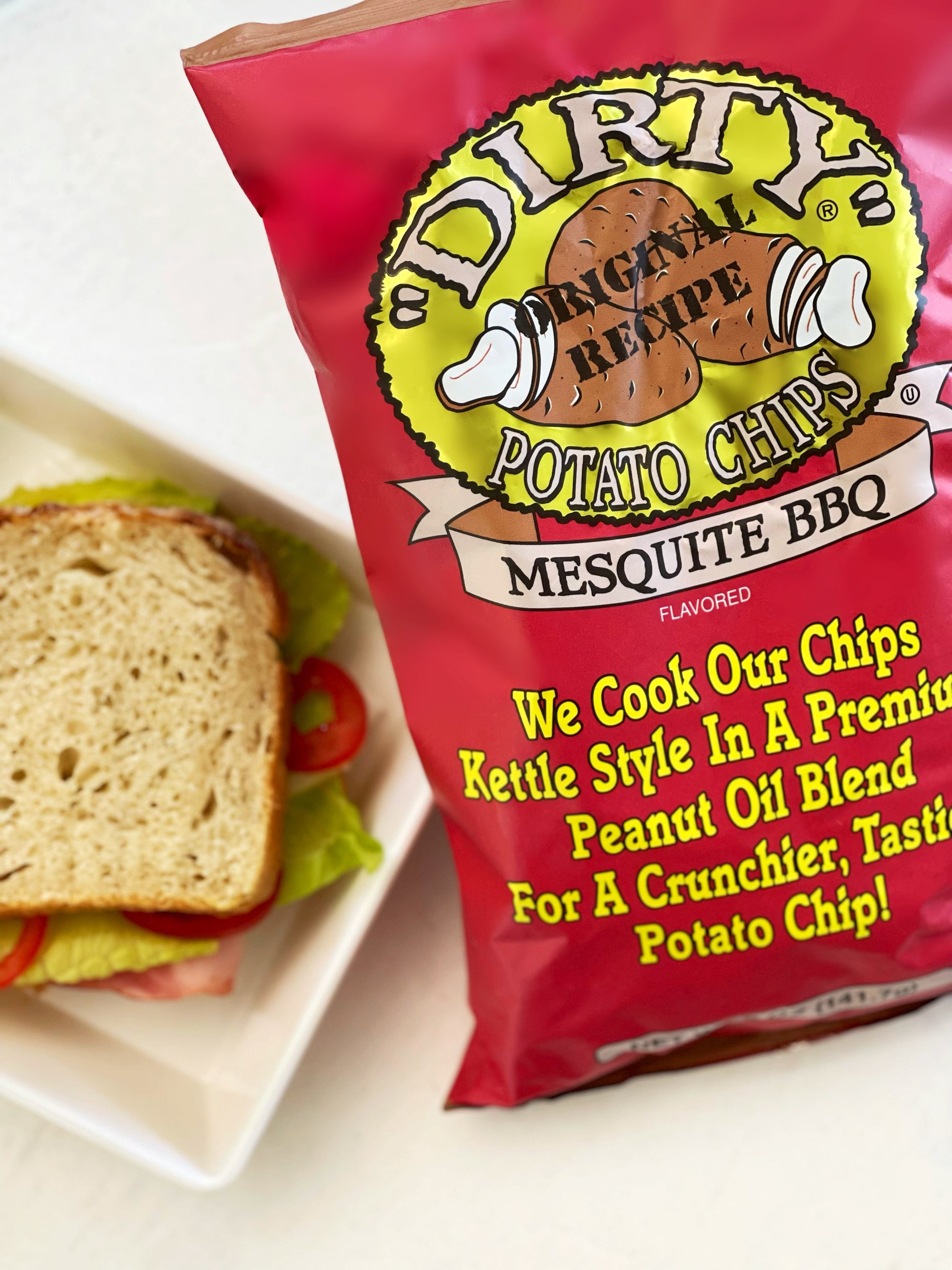 Dirty Potato Chips Mesquite BBQ flavor packet with a sandwich in the background