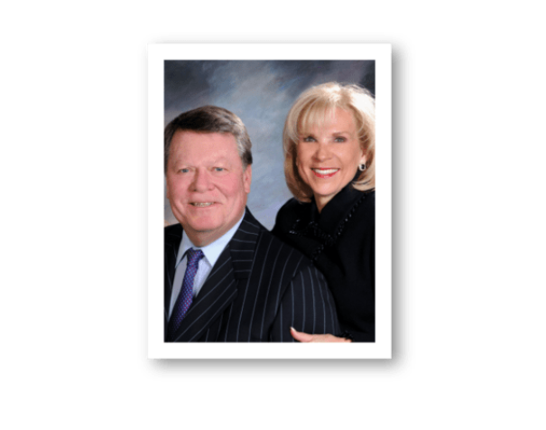 Portrait of a man and woman in formal attire with a blurred background