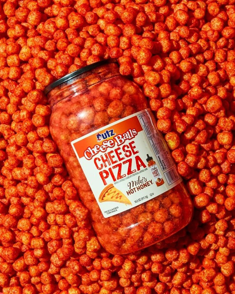Jar of cheese balls with a label on an orange background