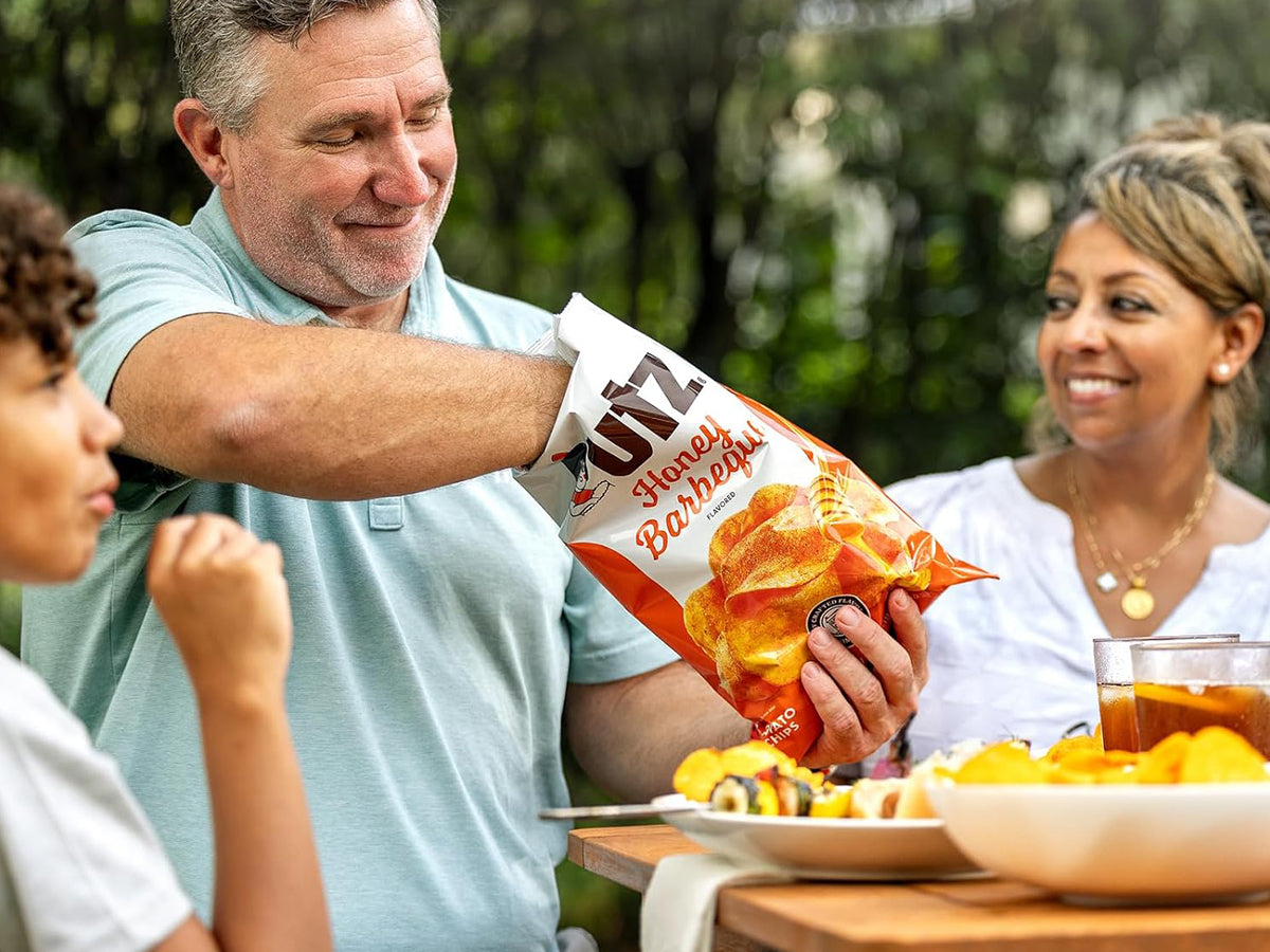 Family enjoying Utz Honey Barbecue chips outdoors