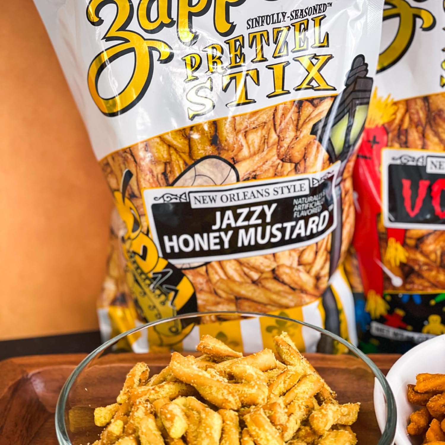 Zapp’s Jazzy Honey Mustard Pretzel Stix bag with bowl of pretzels