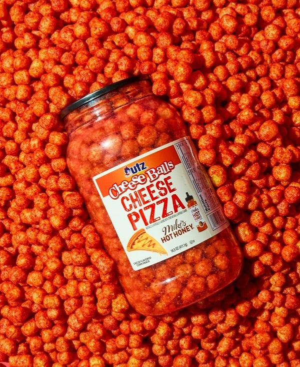 Jar of Cheese Balls Cheese Pizza on a bed of orange cheese balls