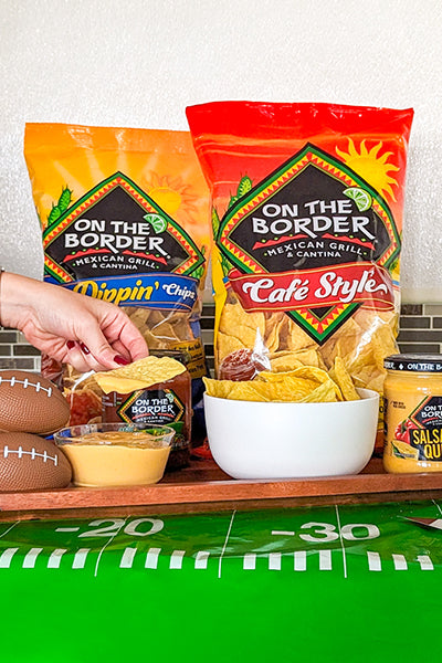 On The Border chips and salsa on a football-themed table
